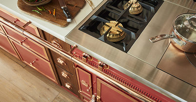 Brass burners and stainless rangetop on a red La Cornue range