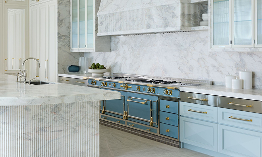 Powder blue La Cornue range in a white marble kitchen